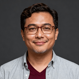AI-generated portrait of a young man with short curly hair and glasses, wearing a button-up shirt and cardigan, posed with a soft smile against a dark gray background in diffused light.