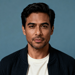 AI-generated portrait of a young man with short styled hair and light stubble, wearing a dark jacket over a shirt, posed with a neutral expression against a textured neutral background in soft balanced light.