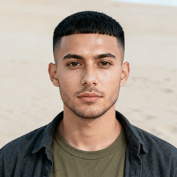 AI-generated portrait of a young man with short cropped hair and trimmed facial hair, wearing a casual jacket, posed with a neutral expression against a light textured background in balanced light.
