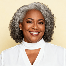 AI-generated portrait of a middle-aged woman with short curly hair and expressive eyes, wearing a light blouse, posed with a joyful smile against a light pastel background with bright lighting.