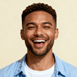 AI-generated portrait of a young man with short curly hair and bright eyes, wearing a casual shirt, posed with an open smile against a light pastel background with high-key lighting.