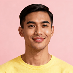 AI-generated portrait of a young man with neatly styled short hair and smooth features, wearing a pastel shirt, posed with an easy smile against a light pink background in even lighting.