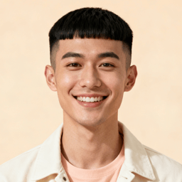 AI-generated portrait of a young man with neatly trimmed hair, wearing a light shirt, posed with a cheerful smile against a pale studio background in even lighting.