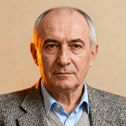 AI-generated portrait of an older man with short graying hair and defined features, wearing a collared shirt and textured blazer, posed with a composed expression against a beige background in soft lighting.