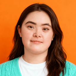 AI-generated portrait of a young woman with long brown hair and rounded facial features, wearing a knit cardigan over a light shirt, posed with a gentle expression against a bright orange background in even studio lighting.