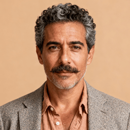 AI-generated portrait of a middle-aged man with salt-and-pepper curly hair and a mustache, wearing a textured blazer and open-collar shirt, posed with a calm expression against a beige background in warm diffused light.