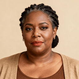 AI-generated portrait of a middle-aged woman with braided hair pulled back, wearing a knit top and cardigan, posed with a composed expression against a warm beige background in soft daylight.