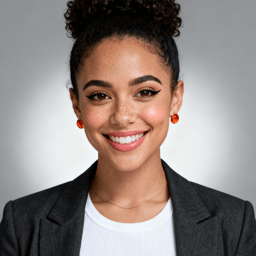 AI-generated portrait of a young woman with curly hair styled up and defined eyebrows, wearing a blazer and earrings, posed with a friendly smile against a soft gray background in clean studio lighting.