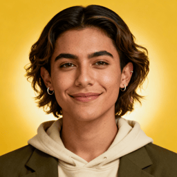 AI-generated portrait of a young person with short wavy hair and natural features, wearing a hoodie layered under a blazer, posed with a calm smile against a yellow background in clean studio lighting.