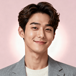 AI-generated portrait of a young man with wavy styled hair and soft features, wearing a blazer over a light sweater, posed with a gentle smile against a pink background in clean studio lighting.