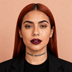 AI-generated portrait of a young woman with long straight hair and facial piercings, wearing a dark blazer and top, posed with a neutral expression against a warm beige background in studio lighting.