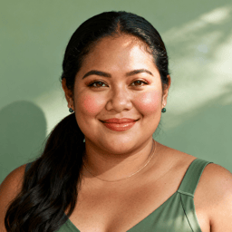 AI-generated portrait of a young woman with straight blond hair tied back, wearing a light blue sleeveless top, posed with a soft smile against a bright neutral background in soft natural light.