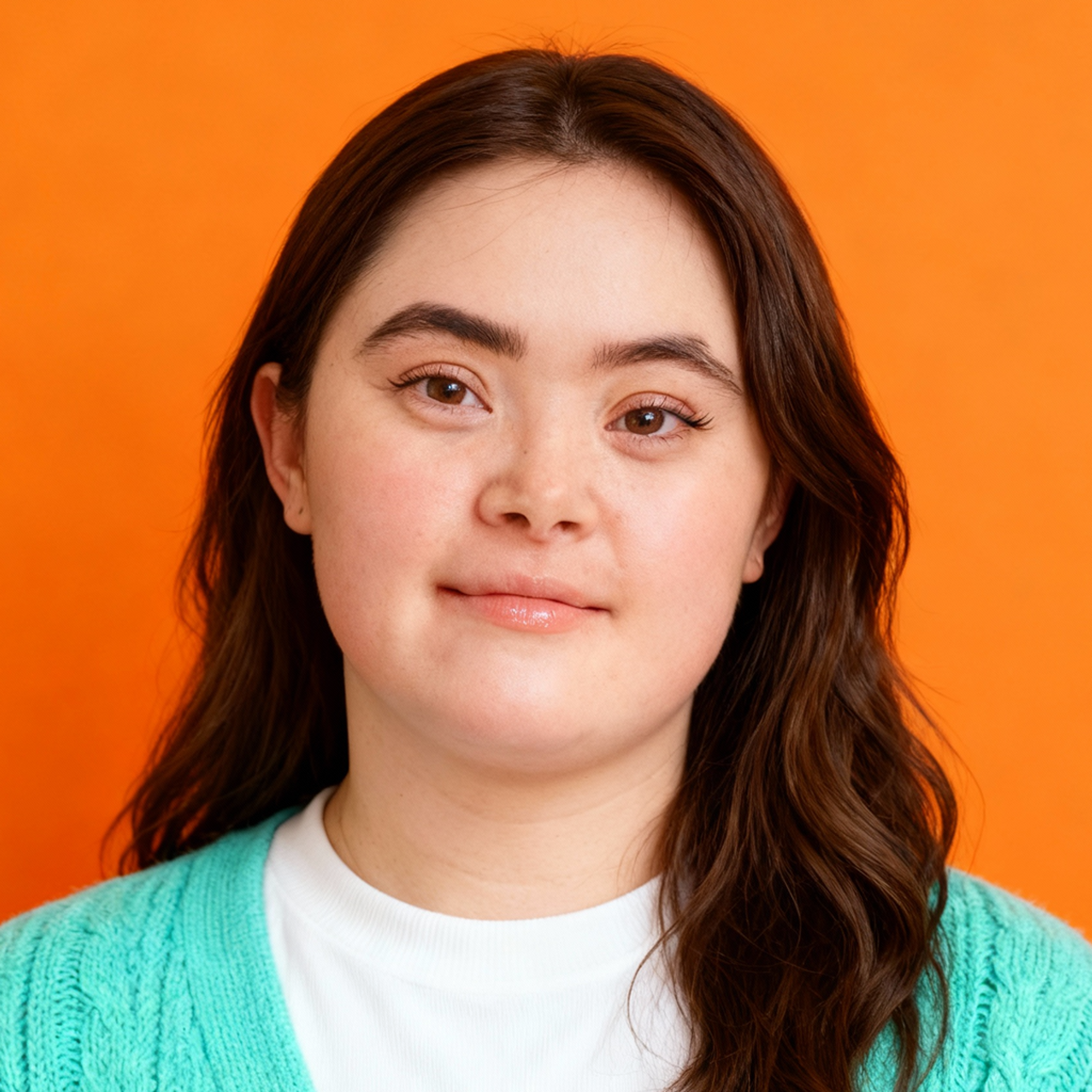 AI-generated portrait of a young woman with long brown hair and rounded facial features, wearing a knit cardigan over a light shirt, posed with a gentle expression against a bright orange background in even studio lighting.