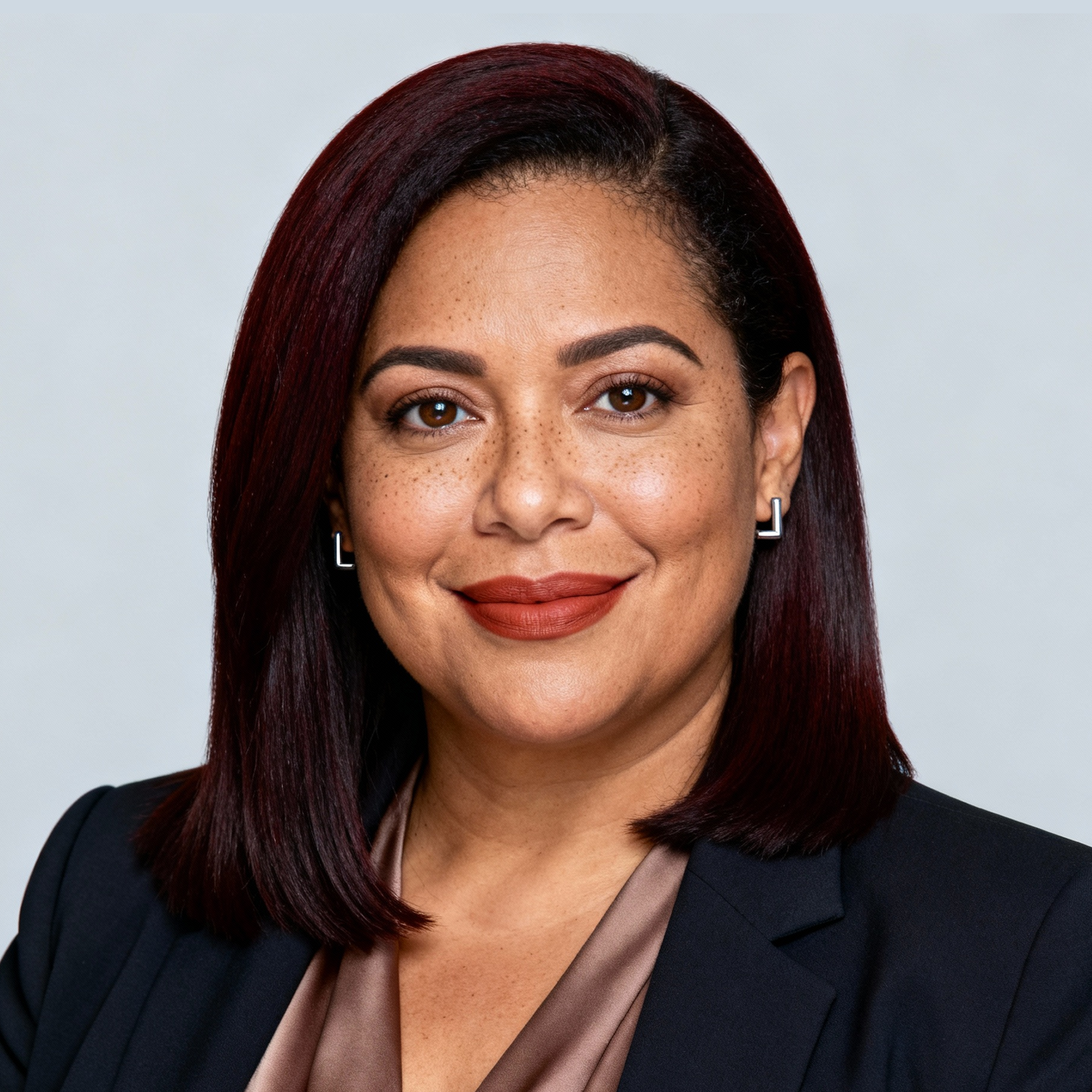 AI-generated portrait of a middle-aged woman with straight shoulder-length hair, wearing a tailored blazer and blouse, posed with a calm expression against a light gray background in controlled studio lighting.