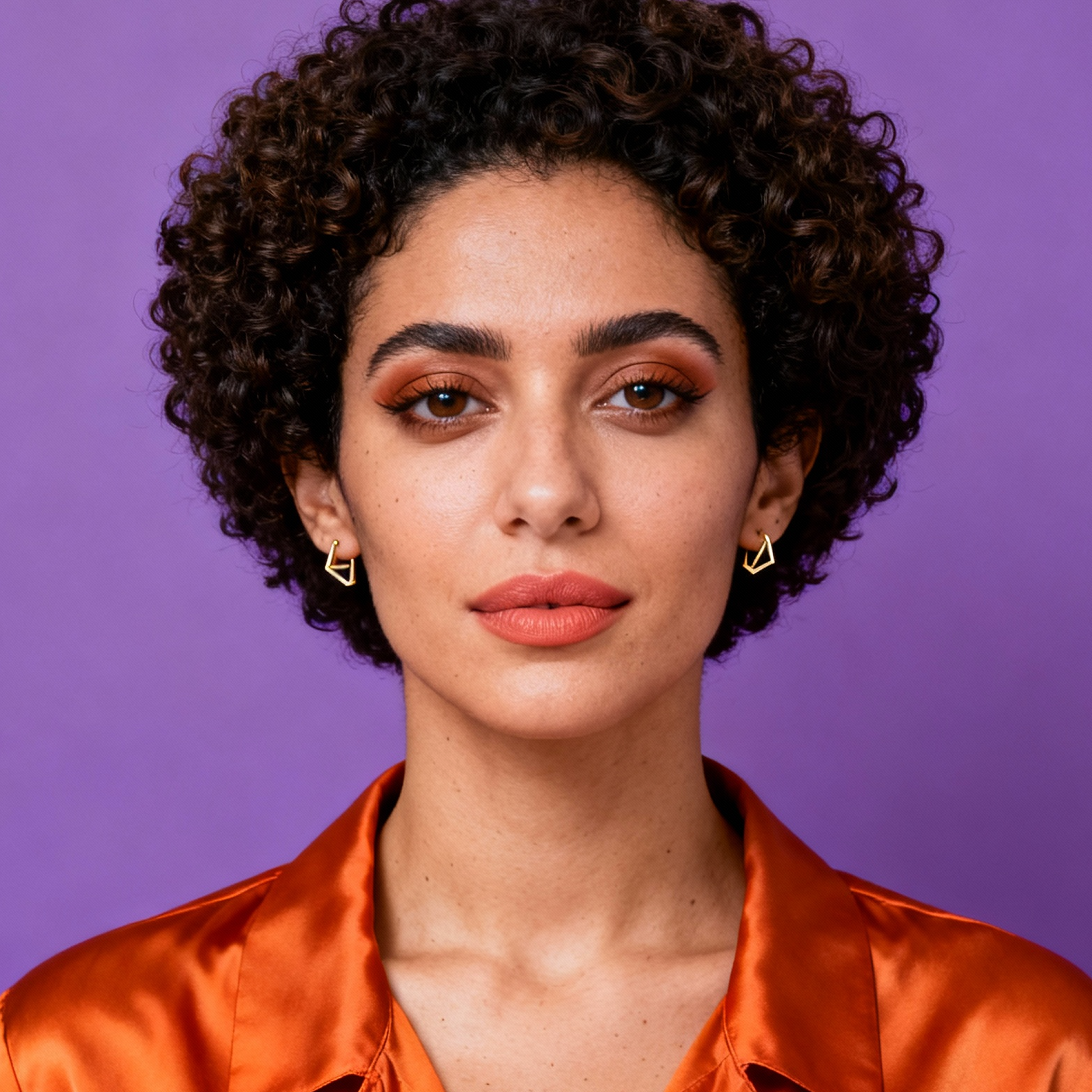 AI-generated portrait of a young woman with short curly hair and defined brows, wearing statement earrings and a satin blouse, posed with a confident expression against a purple background in high-key lighting.